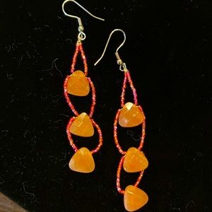 Peach/pink colored stone dangly earrings.